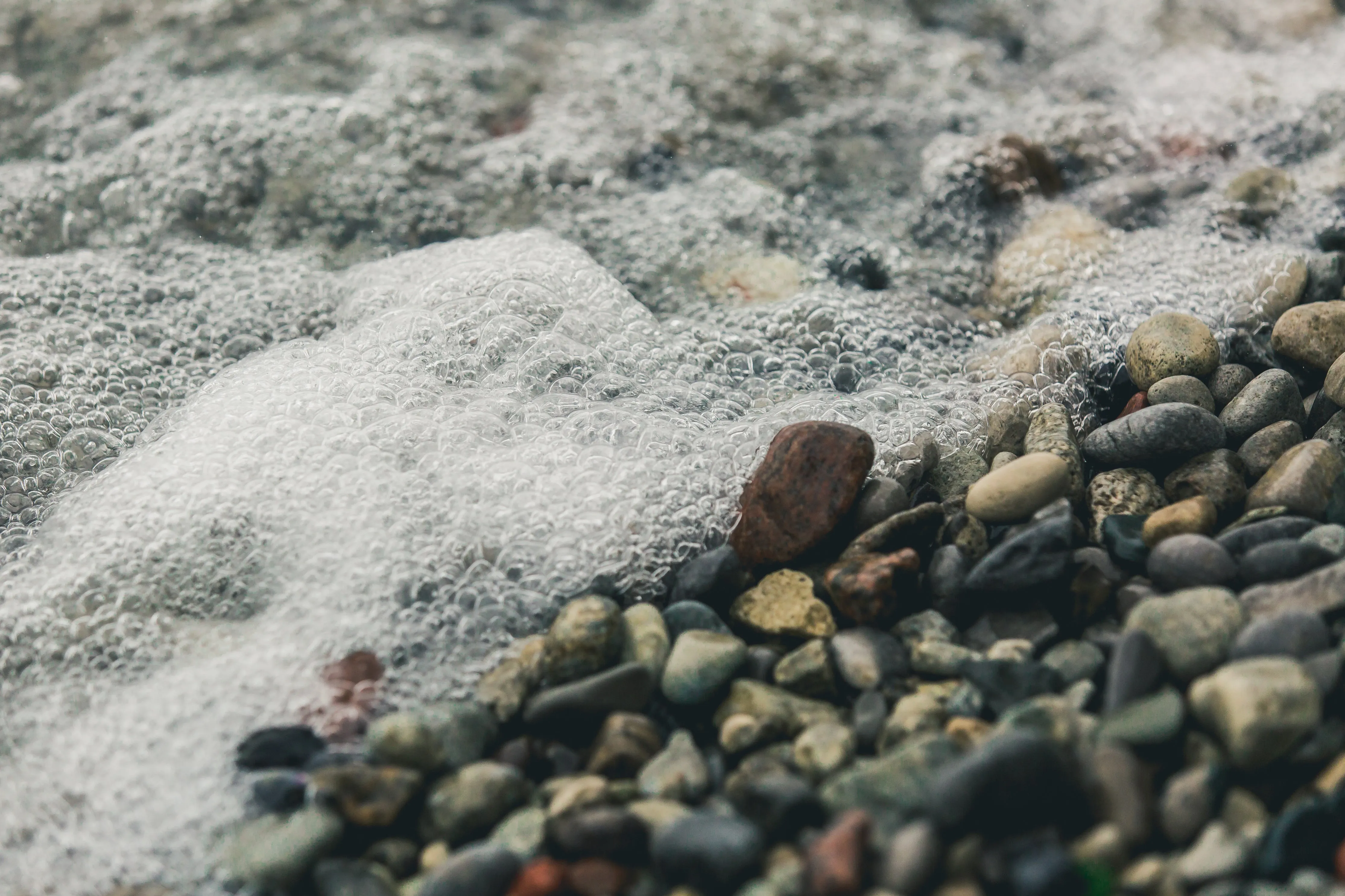 Bubbly water on rocky shore